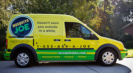 Green and Yellow Mosquito Joe Van parked in Cobb County drive way